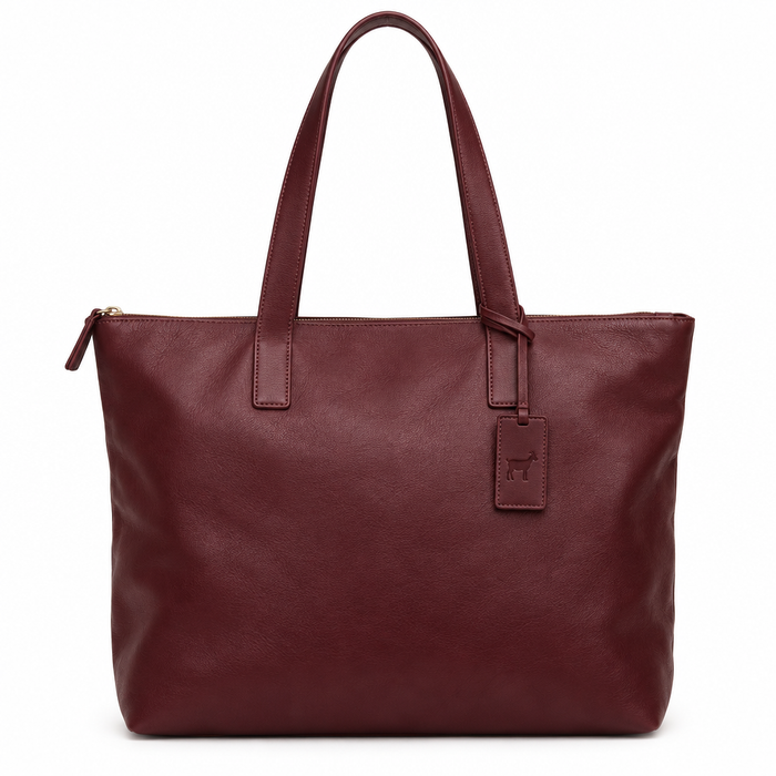 Front view of burgundy sheepskin leather tote bag with shoulder handles and goat-mark tag